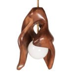 sculptural solid wood pendant light illuminated in modern interior