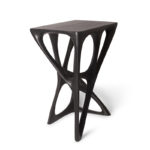 modern sculptural solid wood table from angled perspective