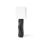 sculptural solid wood table lamp illuminated in modern interior
