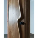 Sculptural solid wood interior door handcrafted in Los Angeles by Amorph Studio